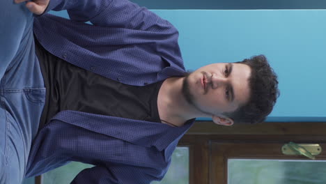 Vertical video of Aggressive and psycho man playing with a knife.