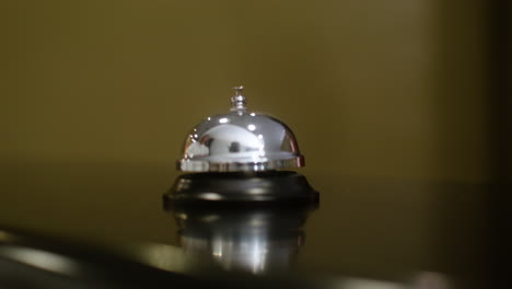 woman pressing the reception desk bell