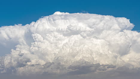 close up time lapse of a large cumulonimbus cloud growing and transforming into an anvil cloud