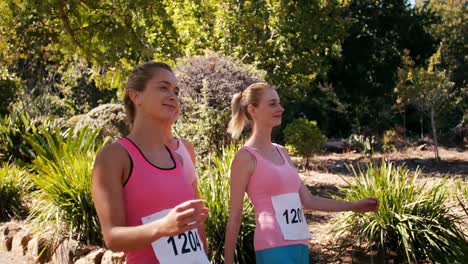 young female athletes walking in park