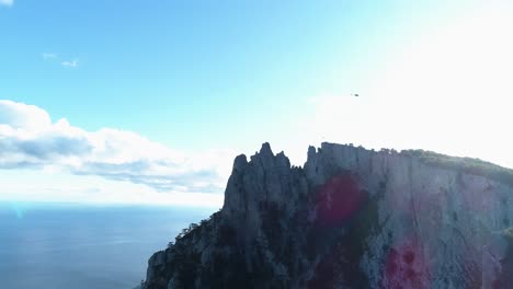 aerial view of rocky mountain peak and ocean