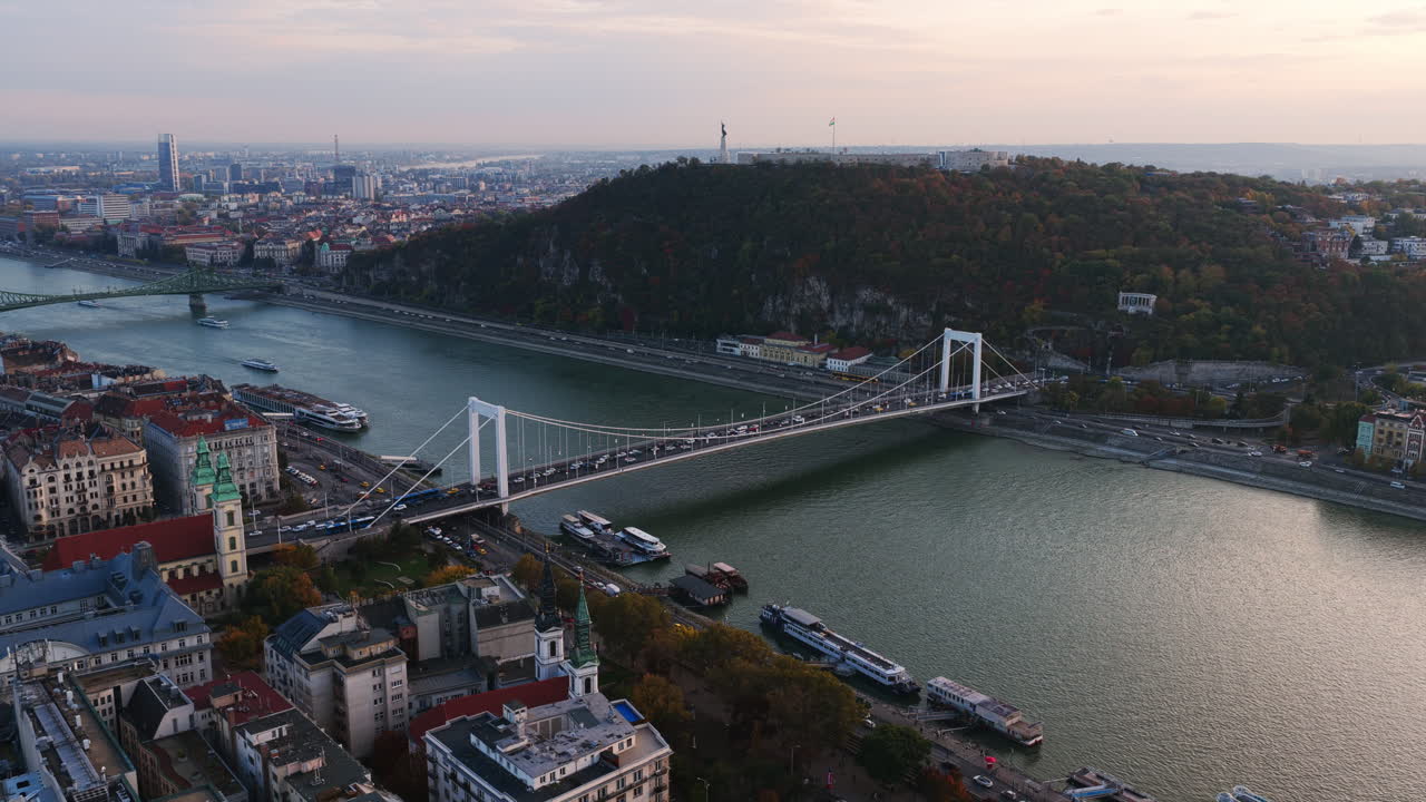 Aerial shot of the Elisabeth Bridge spanning the Danube with Gellért Hill in the background and downtown Budapest on the left