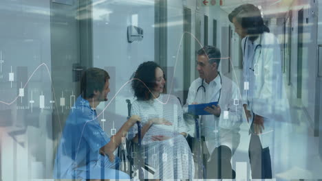 healthcare team consulting pregnant patient in hospital corridor, showing financial chart overlays