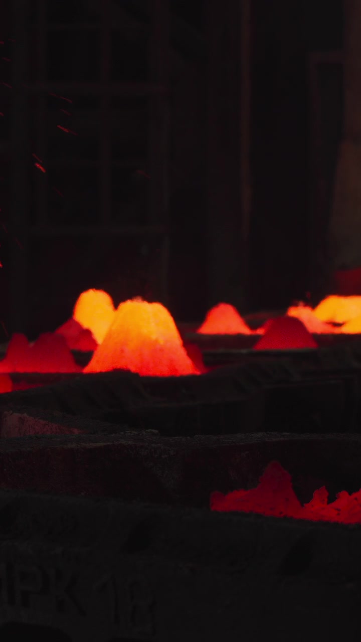 Molten Droplets Cooling On Casting Bed Forming Glowing Mounds, Occasional Spark Bursts, Slow Solidification