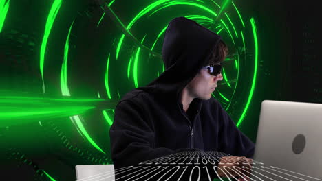 male hacker using laptop against glowing green tunnel