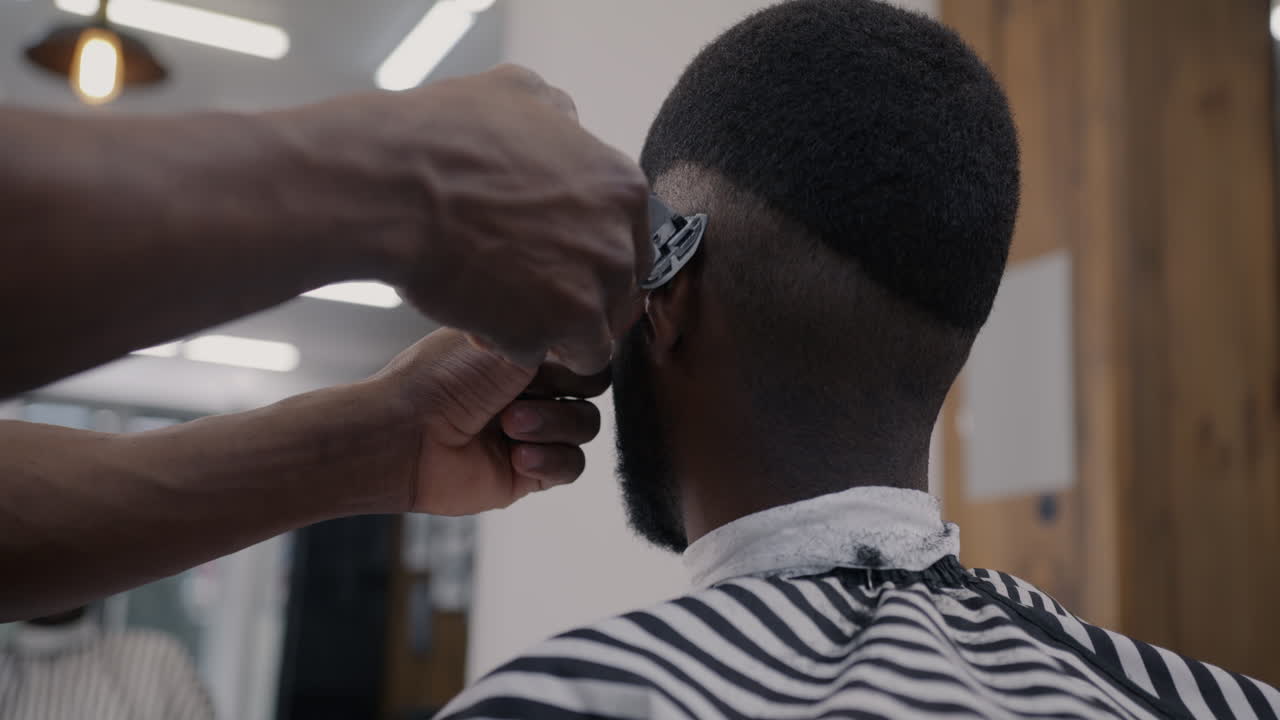 un hombre se corta el cabello en una barbería.