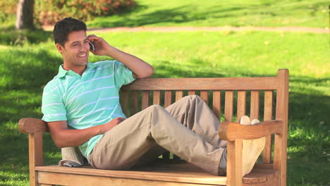 Handsome-man-using-his-phone-outdooors