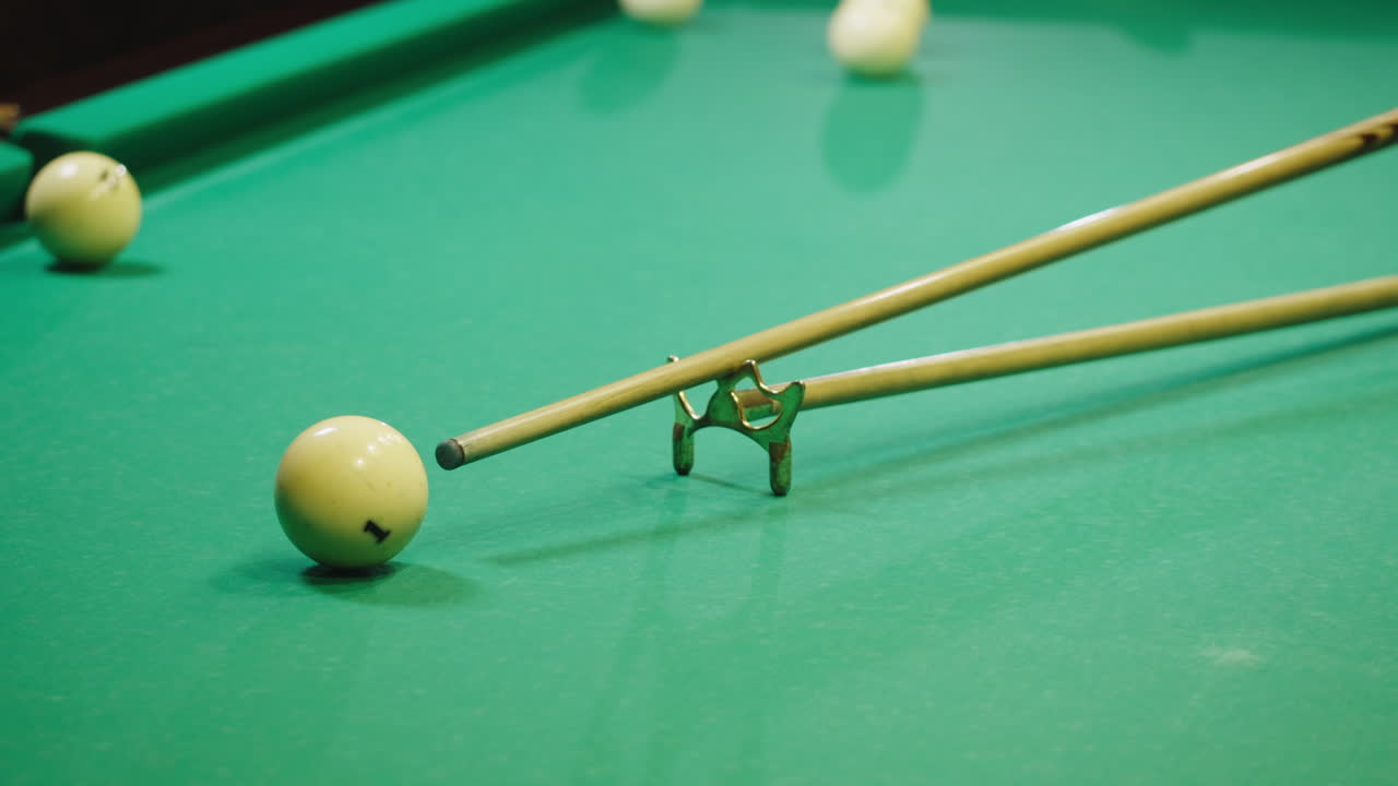 Playing billiard game. White pool balls close-up on green billiards table for start to play. Russian game, Russian pyramid. Billiard balls with numbers on a pool table. Billiards team sport.High quality 4k footage