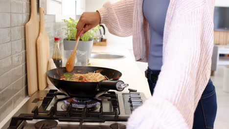 cooking stir-fry, woman in cozy sweater preparing meal in modern kitchen
