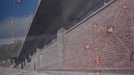 animación de iconos conectados globo sobre hombre afroamericano corriendo junto a la pared de ladrillo
