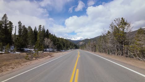 colorado state highway 7 with stunning view of snow-capped rocky mountains. wide shot