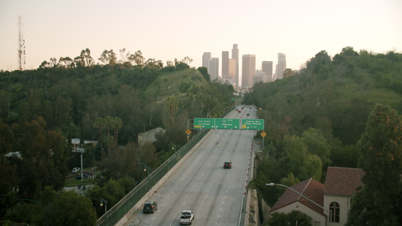 Highway leading to the Los Angeles downtown skyline at dawn or dusk
