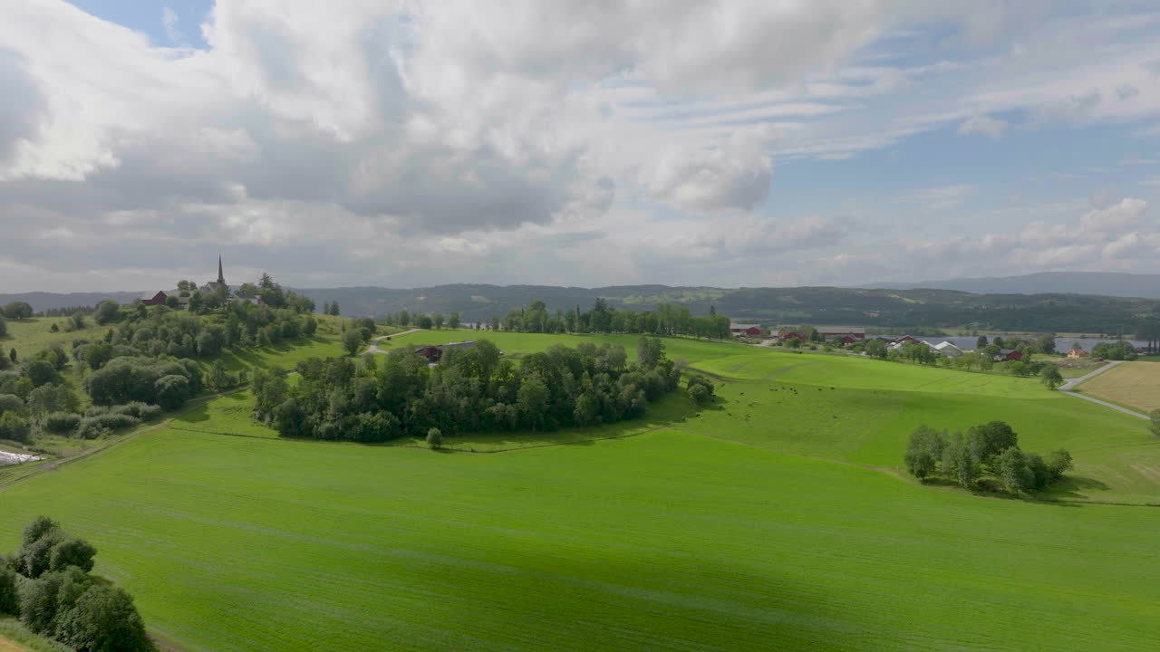 낮에는 언덕 꼭대기에 있는 시골 밀밭, 목초지, 교회