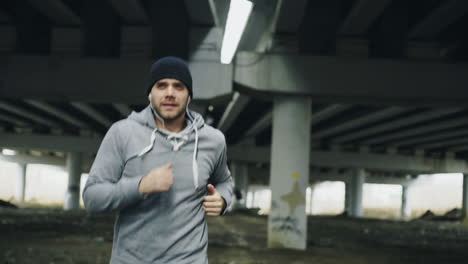 man running under a bridge