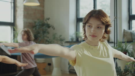 girl practicing yoga on group class