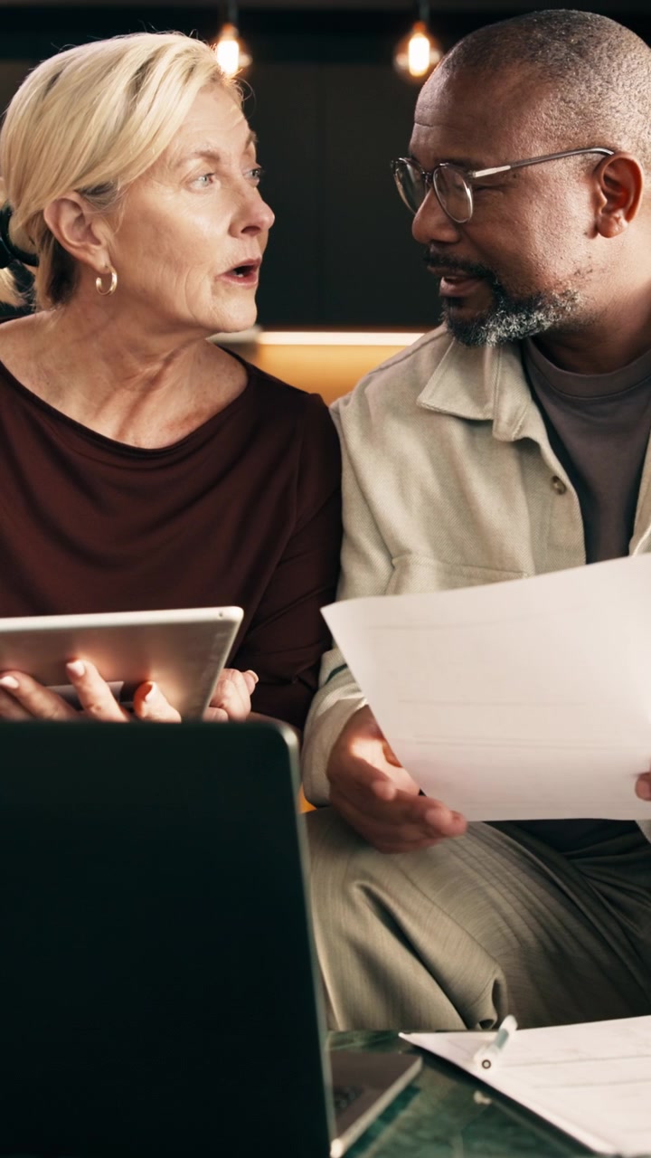 Diverse Business Colleagues Reviewing Documents and Tablet in Office