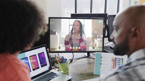 African-american-business-people-on-video-call-with-african-american-female-colleague-on-screen