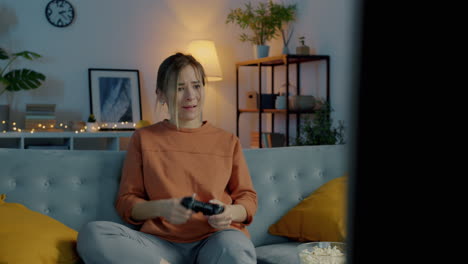 woman playing video game at home