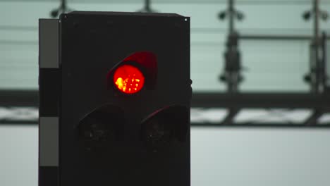 green traffic light with blurred background, signaling go, changing to red and yellow