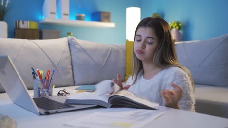 the young woman who is bored with studying is unhappy.