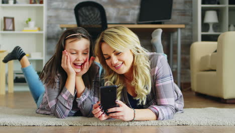 little girl and her mother lying on the floor