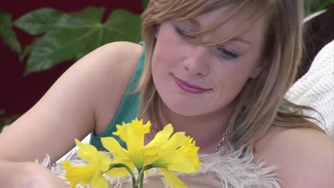 woman smelling a flower