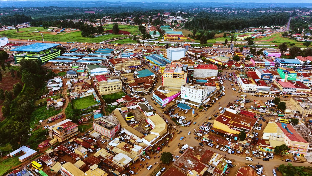 Aerial flyover poor Kitale Slum and modern skyline of Kitale rural urban area of kenya during sunny day. Two class society in Africa.