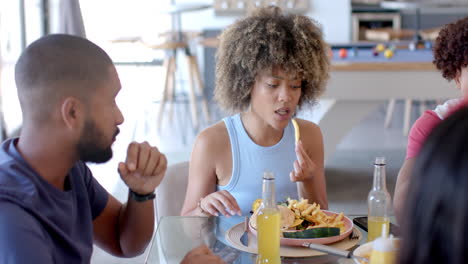 Eating lunch, Diverse friends enjoying food and drinks together at table indoors