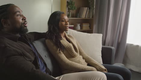 couple at home sitting on sofa in lounge having argument 4