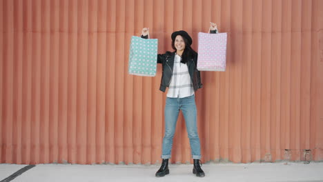 woman shopping spree in front of orange wall