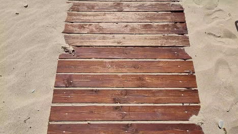 wooden boardwalk on a sandy beach during a warm summer day