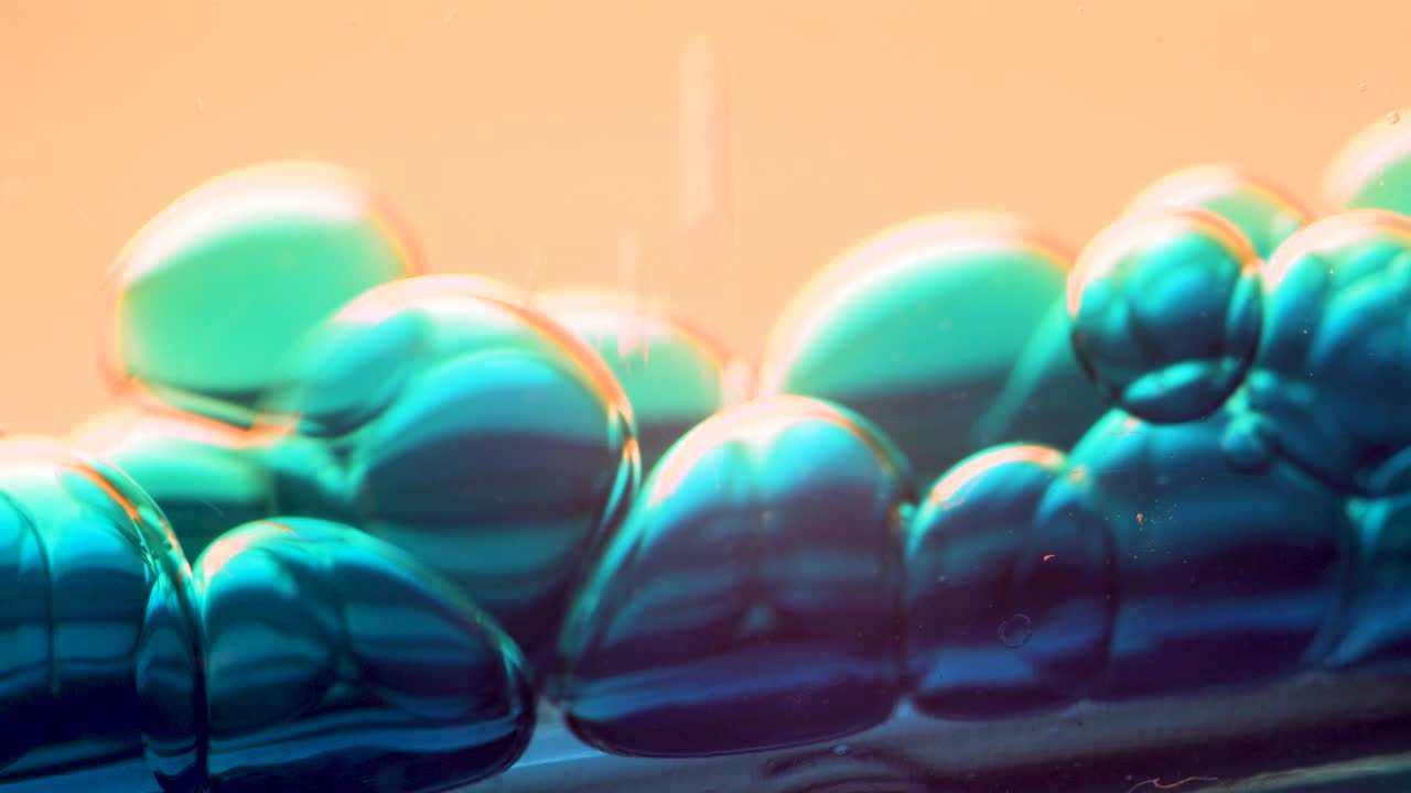 Blue Liquid Bubbles Falling Abstract Macro