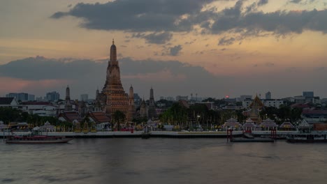 sunset over wat arun, bangkok, thailand
