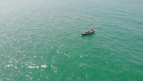 Wooden-Boat-Floating-In-Turquoise-Ocean-Waters-Off-Balochistan