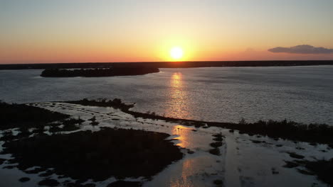 Drone-shot-of-the-salt-marsh-or-wetlands,-aerial-shot-into-the-sun