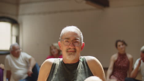 Slow-motion-of-cheerful-grey-haired-senior-man-in-dance-studio