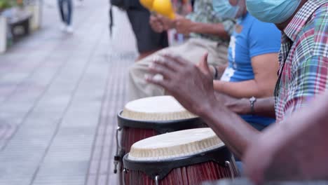 salsa band plays in the street the count in the middle of the pandemic, to earn a living