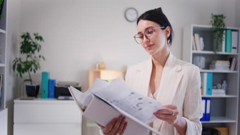 female office worker looking through company documents