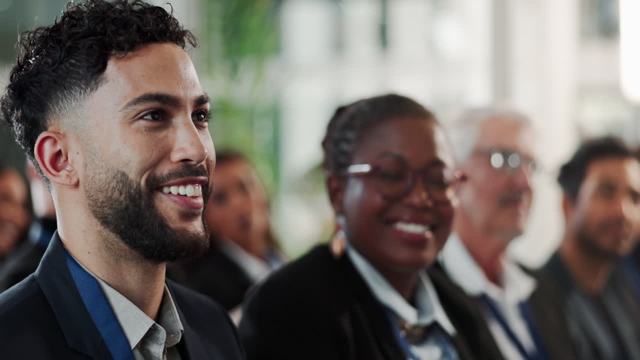 Diverse audience listening intently to a speaker at a business conference