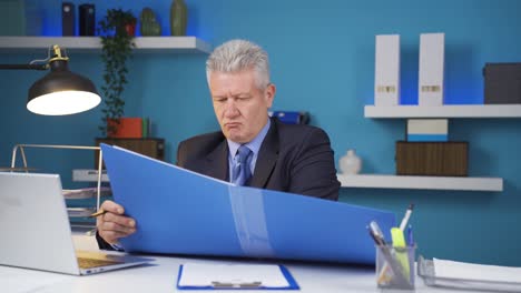 enraged businessman closes paperwork files.