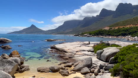 oudekraal beach scenic view cape town south africa table mountain boulders is sea lions head stunning ocean mountain coastline aqua deep blue crystal clear water clouds rolling over peaks to the left