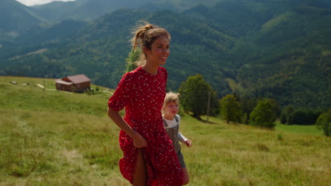 woman showing daughter mountains views sunny day. mother walking with girl.