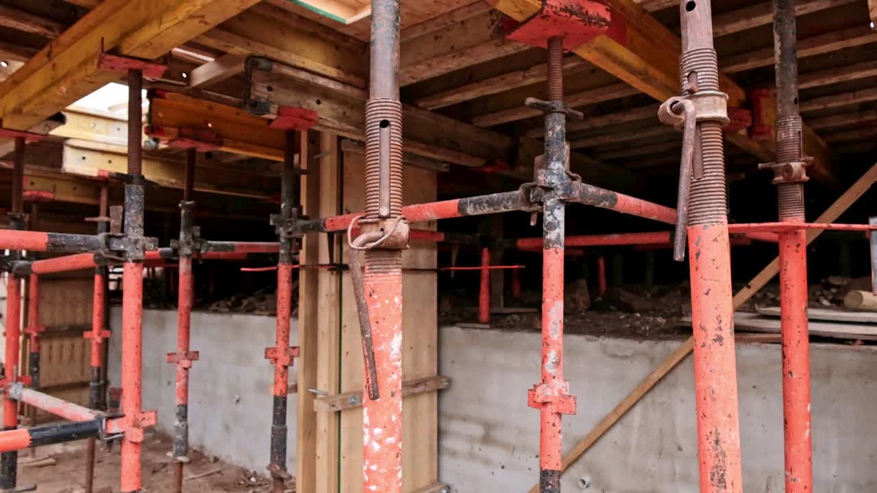 Scaffolding is set up to back prop against form work to support a concrete cast