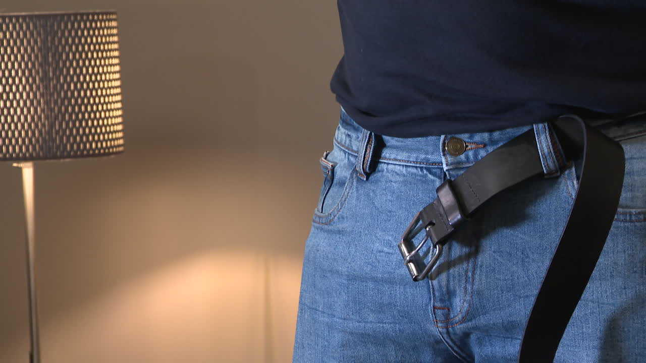 Man fastening a belt