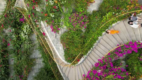 slow tilting shot of a tourist in a dress walking down the dragon stairs in thang rong