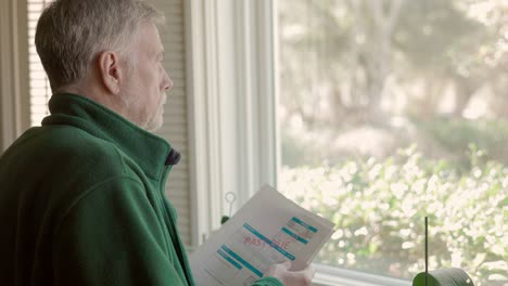 senior citizen going over past due bills in his home