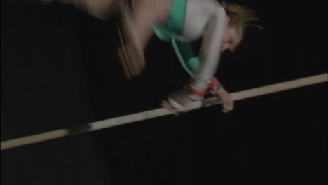 a gymnast performs on the uneven bars