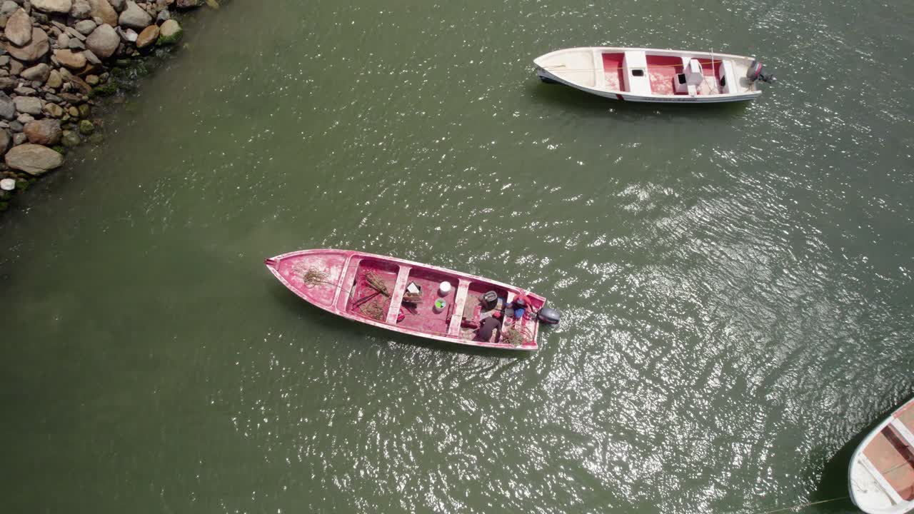An aerial drone view captured after a fishing boat leaves the bay to go fishing.