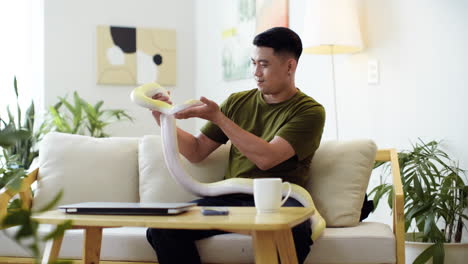 man holding snake indoors