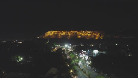 Aerial-drone-shot-of-Gwalior-city-during-night-time-with-light-traffic-on-road-in-Madhya-Pradesh-India